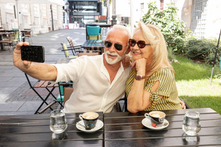 couple drinking coffee taking selfie