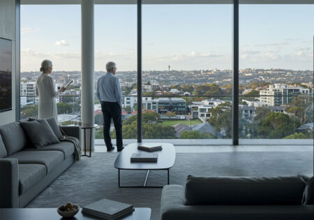 senior couple in a luxurious apartment overlooking sydney inner west suburbs